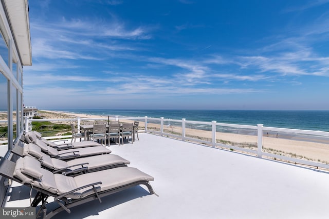 exterior space featuring a water view and a beach view