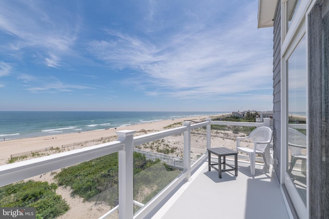 balcony with a view of the beach and a water view