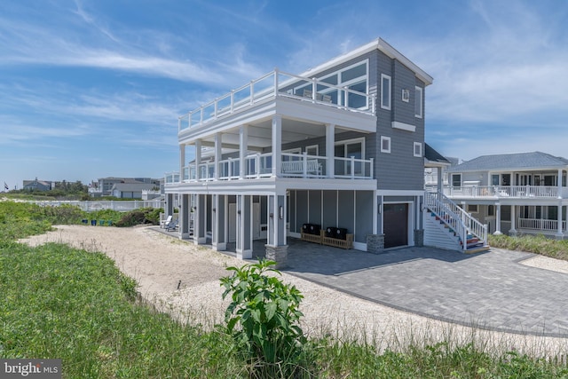 exterior space featuring a garage and a balcony