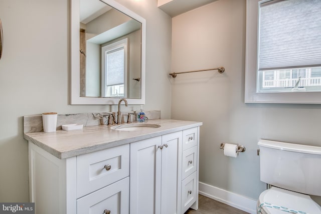 bathroom featuring vanity and toilet