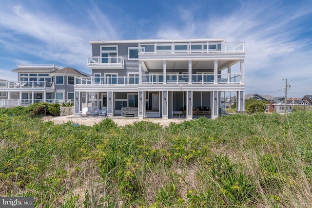 back of house with a balcony and a patio