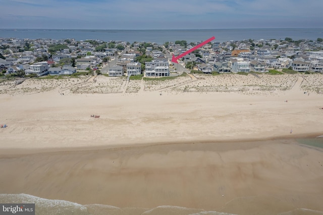 bird's eye view with a water view and a view of the beach