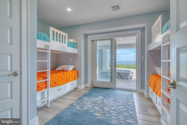 bedroom featuring access to outside and light hardwood / wood-style flooring