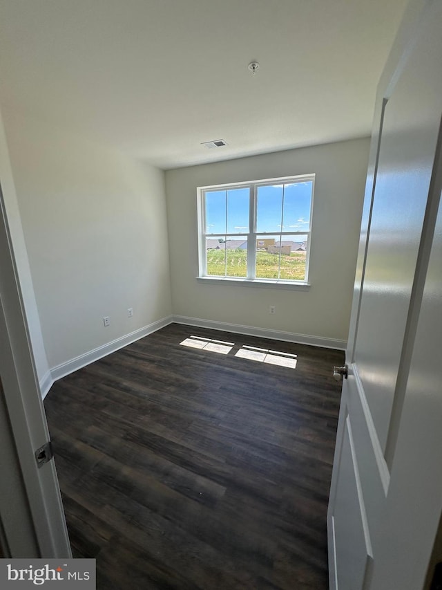 empty room featuring dark hardwood / wood-style floors