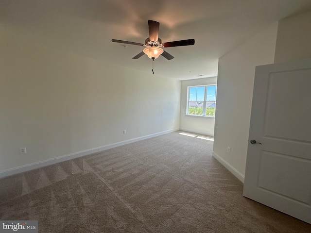 empty room featuring carpet flooring and ceiling fan