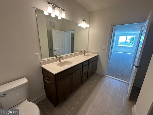 bathroom with tile patterned floors, vanity, and toilet