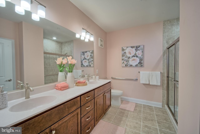 bathroom with vanity, an enclosed shower, and toilet