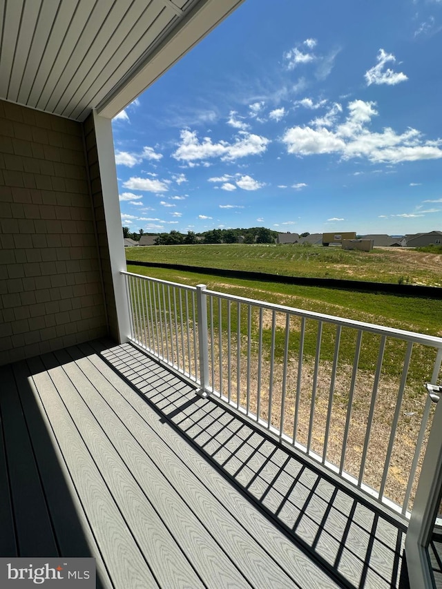 wooden deck with a rural view