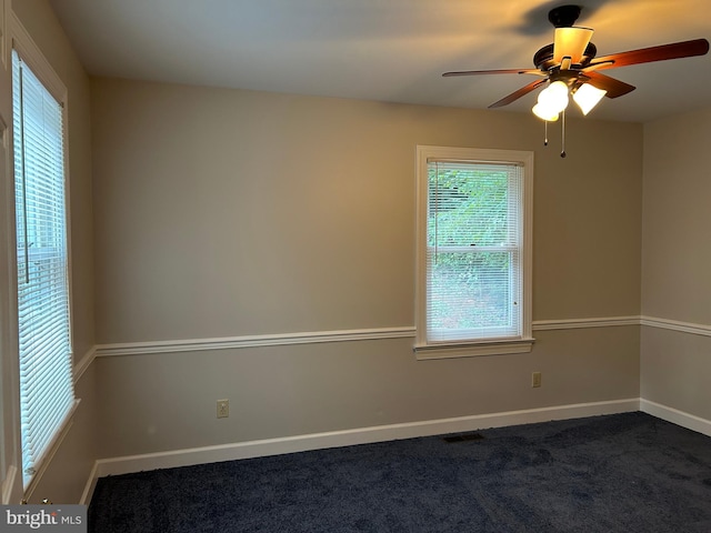 carpeted spare room featuring ceiling fan