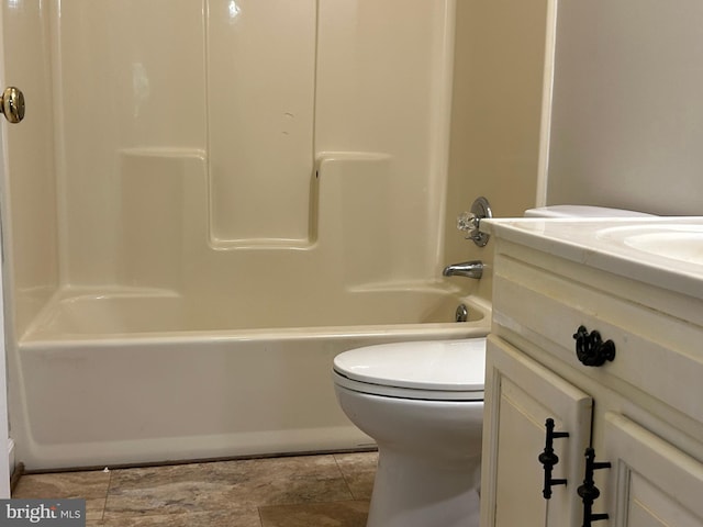 full bathroom featuring toilet, tile patterned floors, vanity, and shower / washtub combination