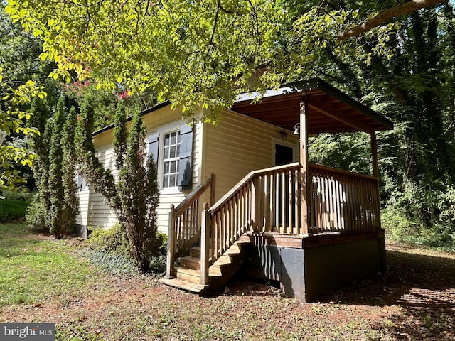 back of house featuring a wooden deck