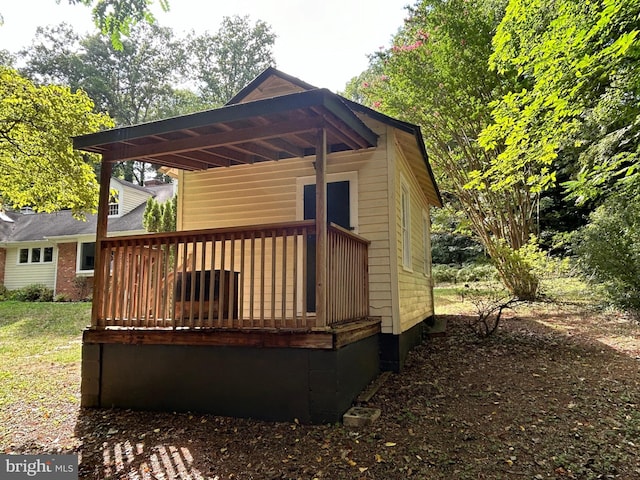 back of house featuring a wooden deck