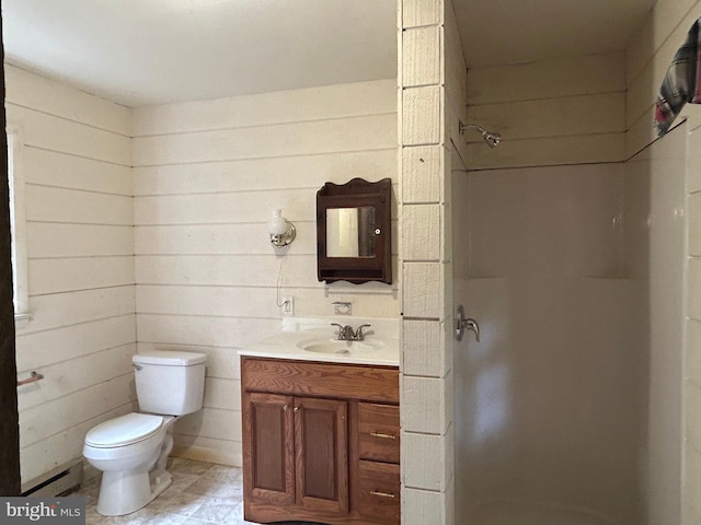 bathroom with baseboard heating, walk in shower, toilet, tile patterned floors, and vanity