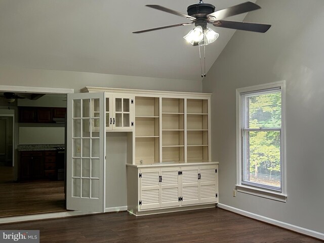 interior space with vaulted ceiling, dark wood-type flooring, ceiling fan, and a healthy amount of sunlight