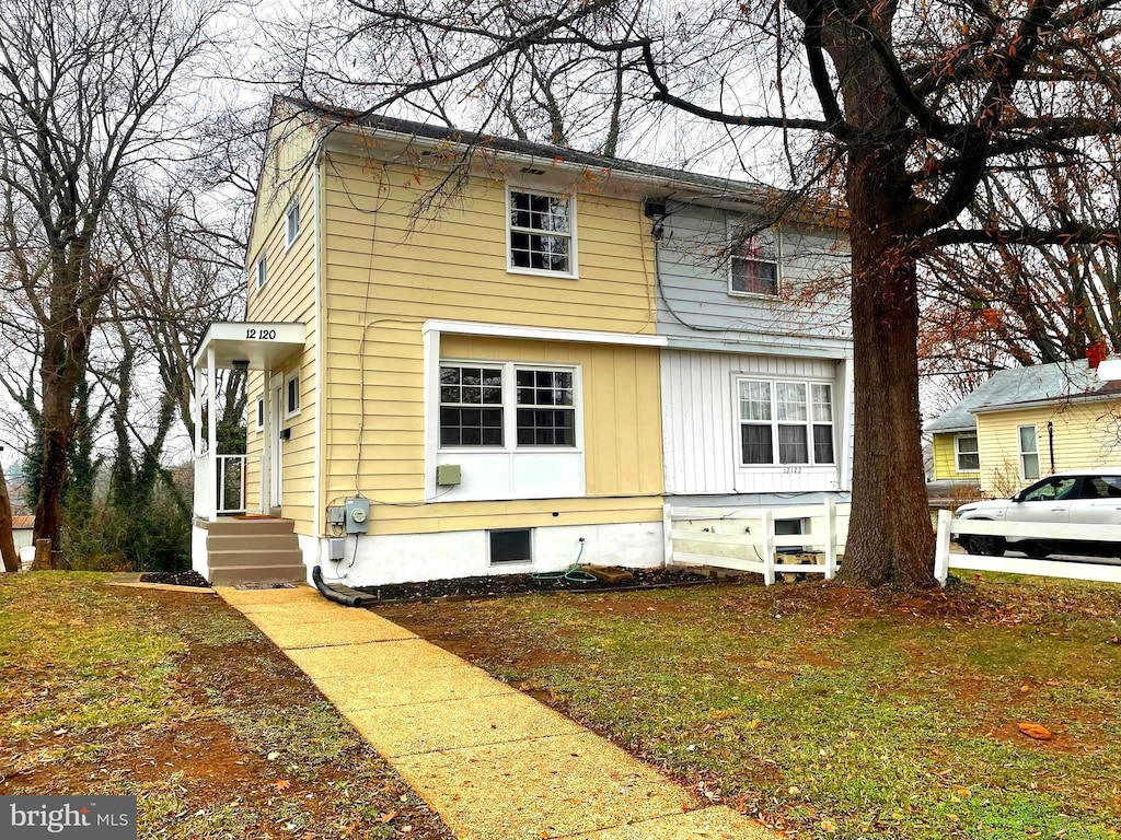 view of side of home featuring a lawn