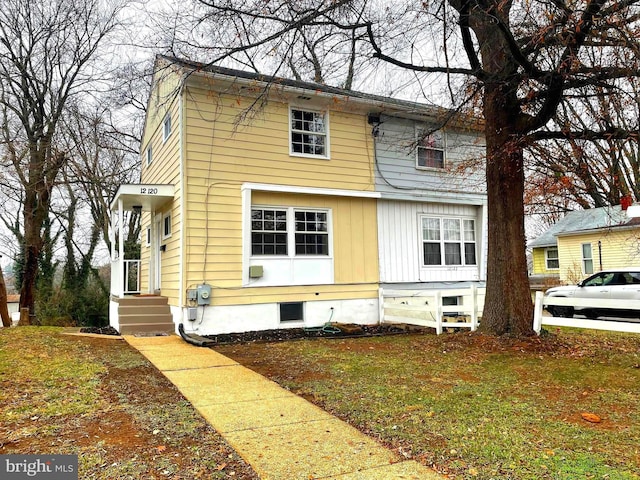 view of side of home featuring a lawn