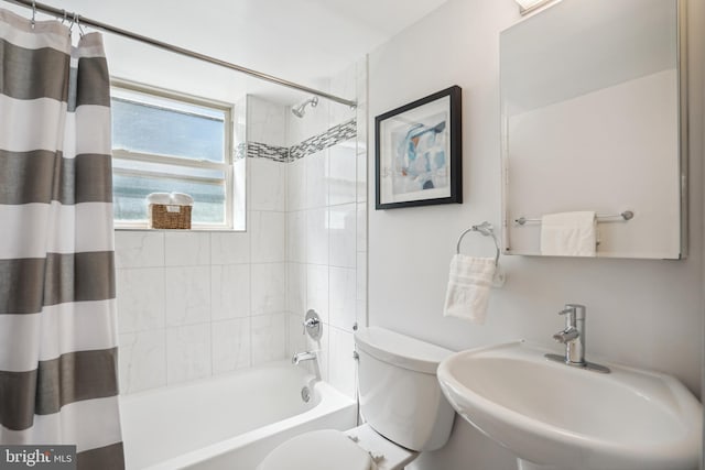 full bathroom with toilet, sink, and shower / tub combo with curtain