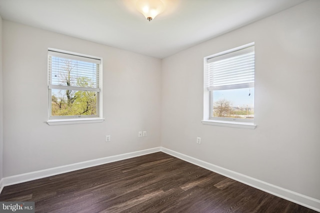 spare room featuring dark hardwood / wood-style floors