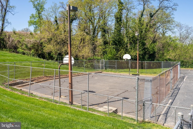 view of sport court with a yard and basketball court