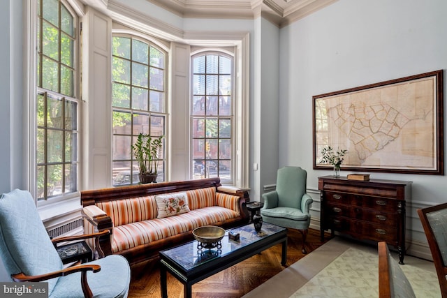 living area featuring light parquet floors and ornamental molding