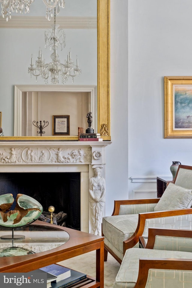 living area with ornamental molding and a chandelier