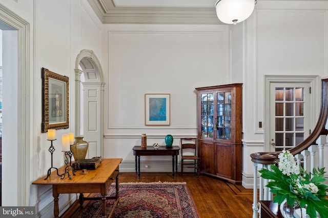 interior space featuring ornamental molding and dark wood-type flooring