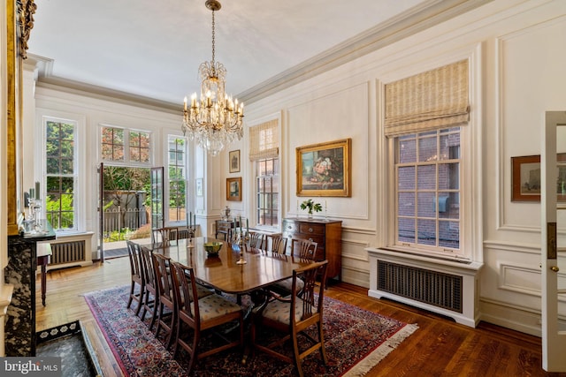 dining space featuring crown molding, a notable chandelier, radiator heating unit, and dark hardwood / wood-style floors