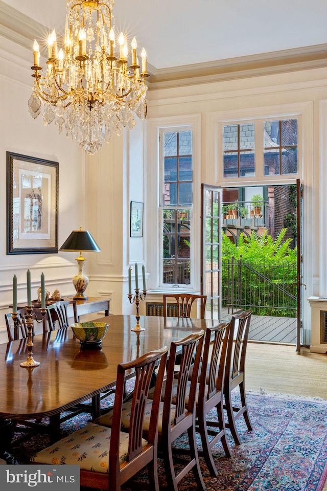 dining space featuring crown molding and a chandelier