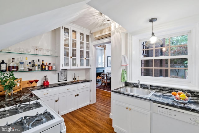 kitchen featuring white cabinetry, dishwasher, a healthy amount of sunlight, and decorative light fixtures