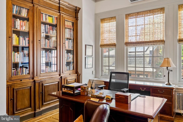 office area featuring a wealth of natural light and hardwood / wood-style floors