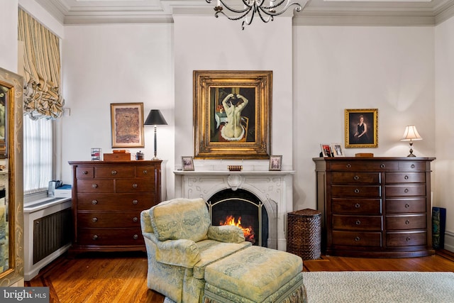 sitting room featuring crown molding and hardwood / wood-style flooring