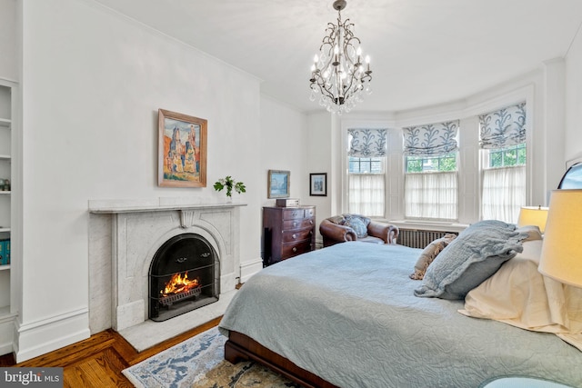 bedroom featuring crown molding, a notable chandelier, and hardwood / wood-style floors