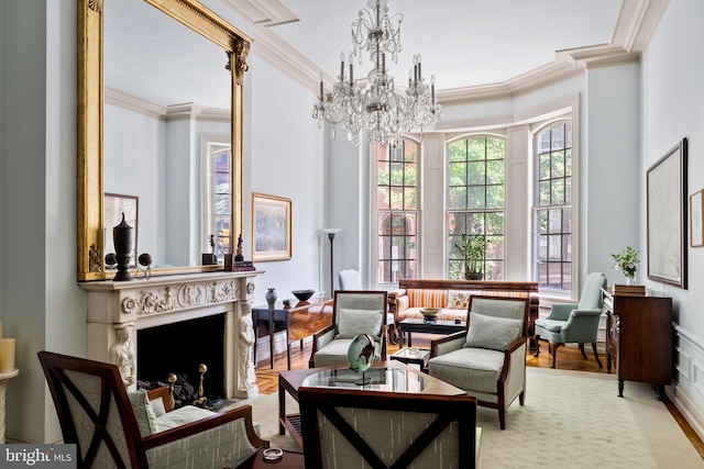 living area featuring ornamental molding, light hardwood / wood-style flooring, and a high end fireplace