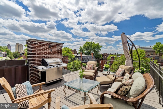 deck with an outdoor living space and area for grilling