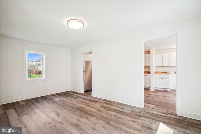 unfurnished room featuring light hardwood / wood-style flooring