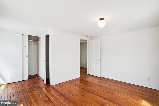 unfurnished bedroom with a closet and wood-type flooring