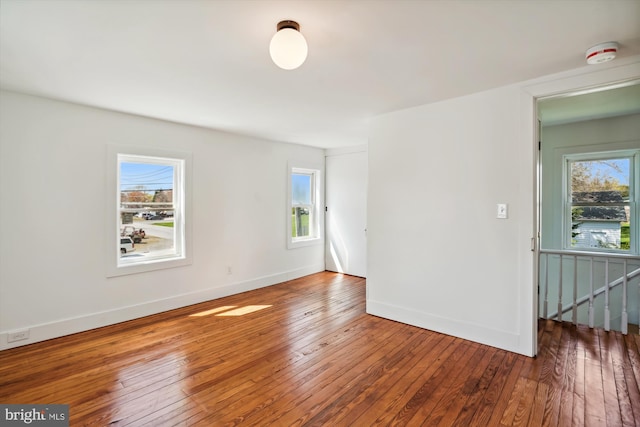 empty room featuring a wealth of natural light and hardwood / wood-style flooring