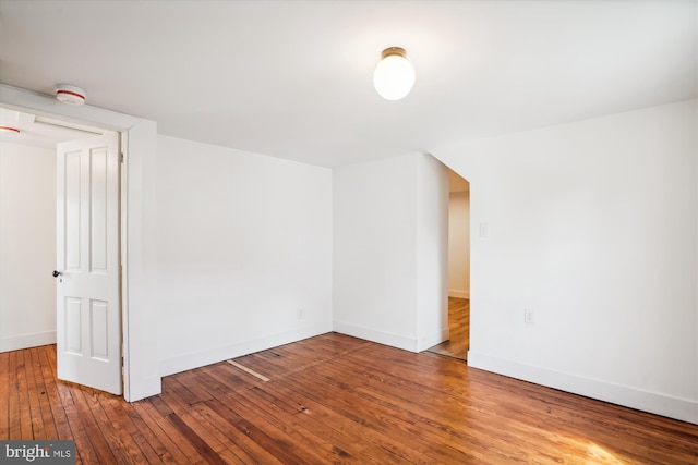 additional living space featuring hardwood / wood-style floors