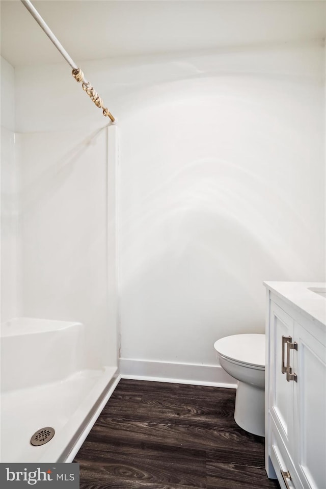 bathroom with hardwood / wood-style floors, vanity, and toilet