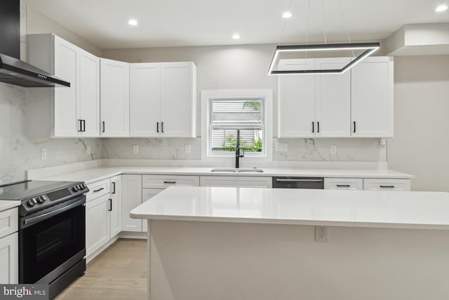 kitchen with stainless steel appliances, white cabinetry, a wealth of natural light, and sink