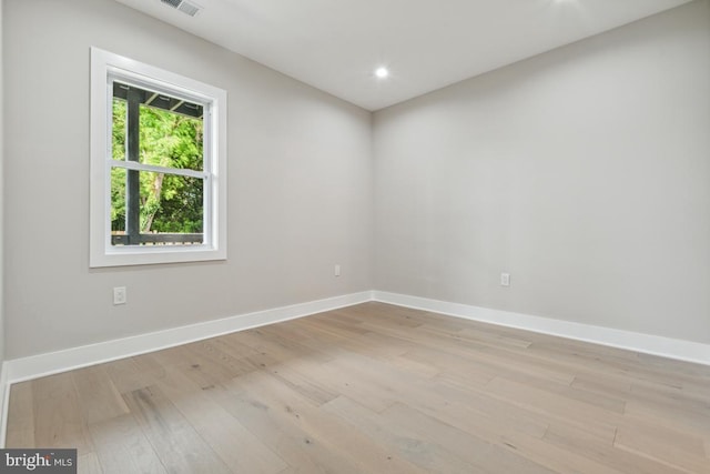 unfurnished bedroom with ensuite bath and light wood-type flooring