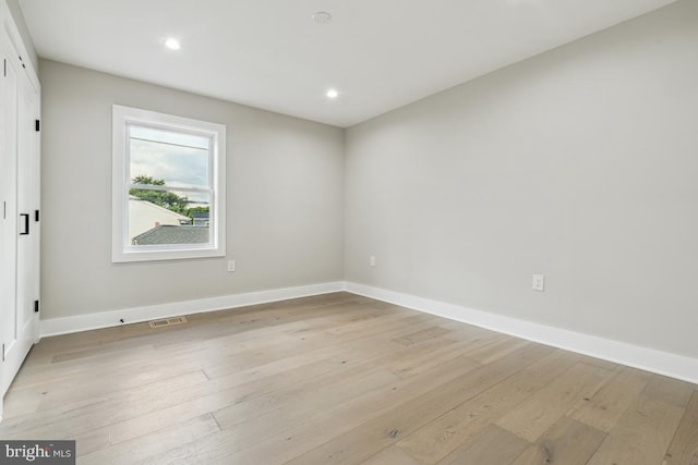 unfurnished room featuring light hardwood / wood-style floors and plenty of natural light