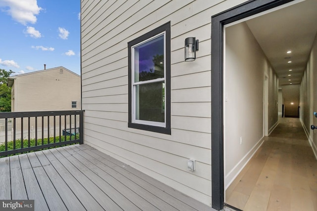 back of house featuring a lawn, a deck, and central AC