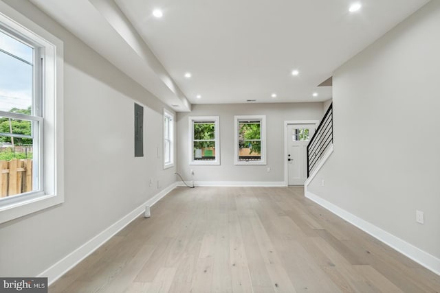 kitchen featuring white cabinets, a center island, black fridge, and hanging light fixtures