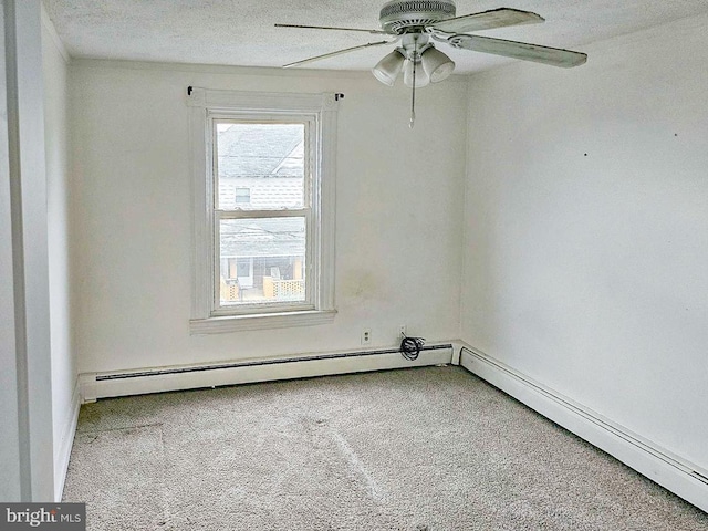 carpeted empty room featuring ceiling fan and a baseboard radiator