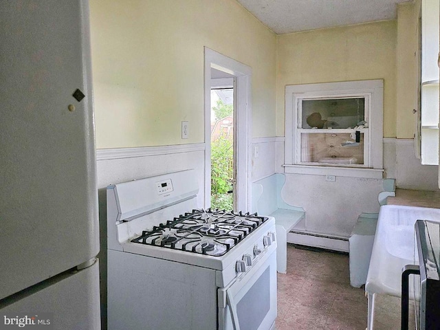 kitchen with white appliances and a baseboard heating unit