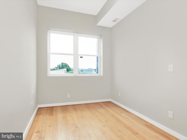 empty room with light hardwood / wood-style flooring