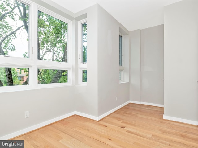 unfurnished room with hardwood / wood-style floors