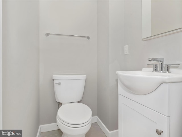 bathroom featuring tile patterned flooring, vanity, and toilet