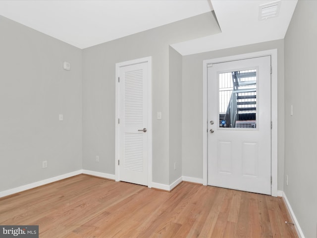 foyer entrance with light hardwood / wood-style floors